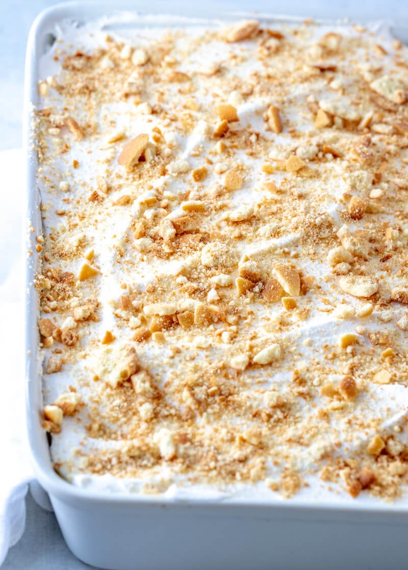 Chilled Banana Pudding in white dish topped with crushed vanilla wafers
