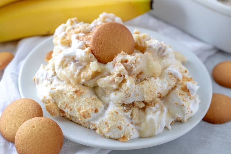 White plate full of southern banana pudding topped with crushed vanilla wafers