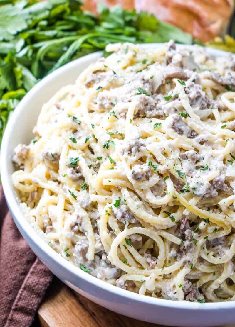 Ground Beef Carbonara in large round serving bowl sprinkled with parsley flakes