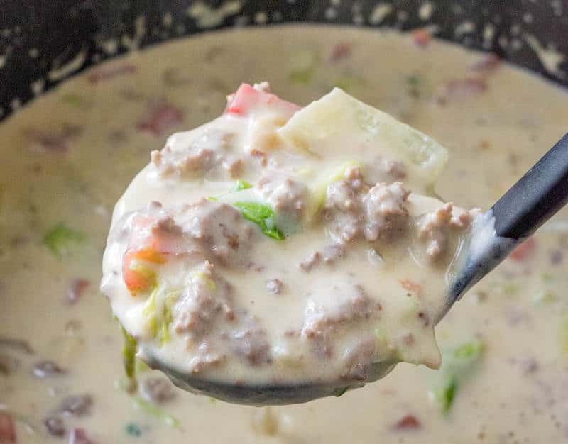 Ladle of Cheeseburger Soup coming out of pot