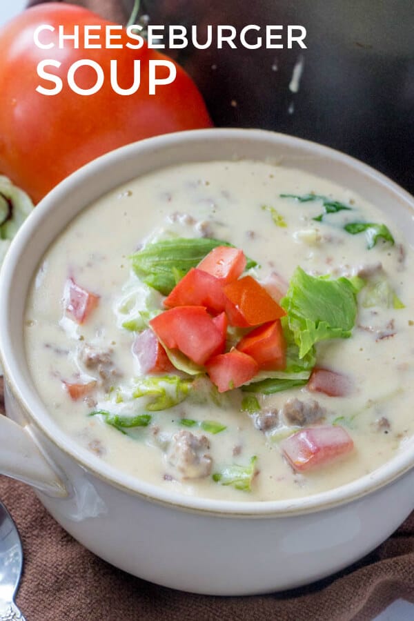 Pinterest image of cheeseburger soup in bowl topped with diced tomatoes and lettuce