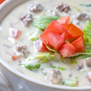 Cheeseburger soup in white bowl