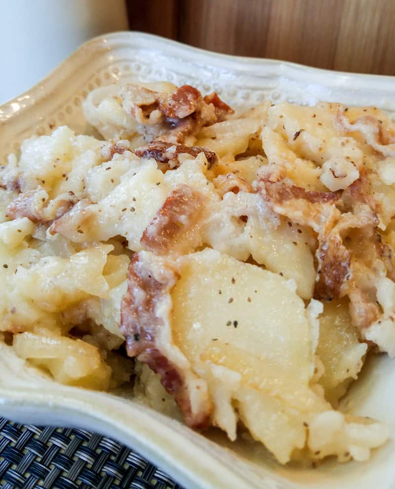 Up close of potato salad in bowl showing bacon pieces