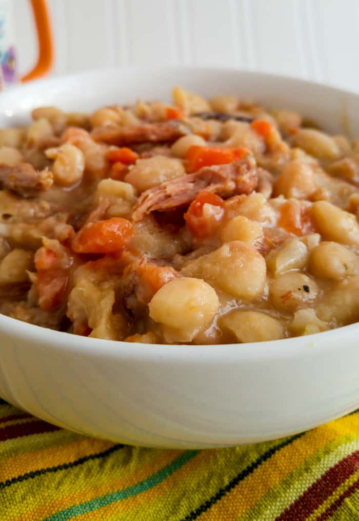 Up close image of soup in bowl showing off beans and ham