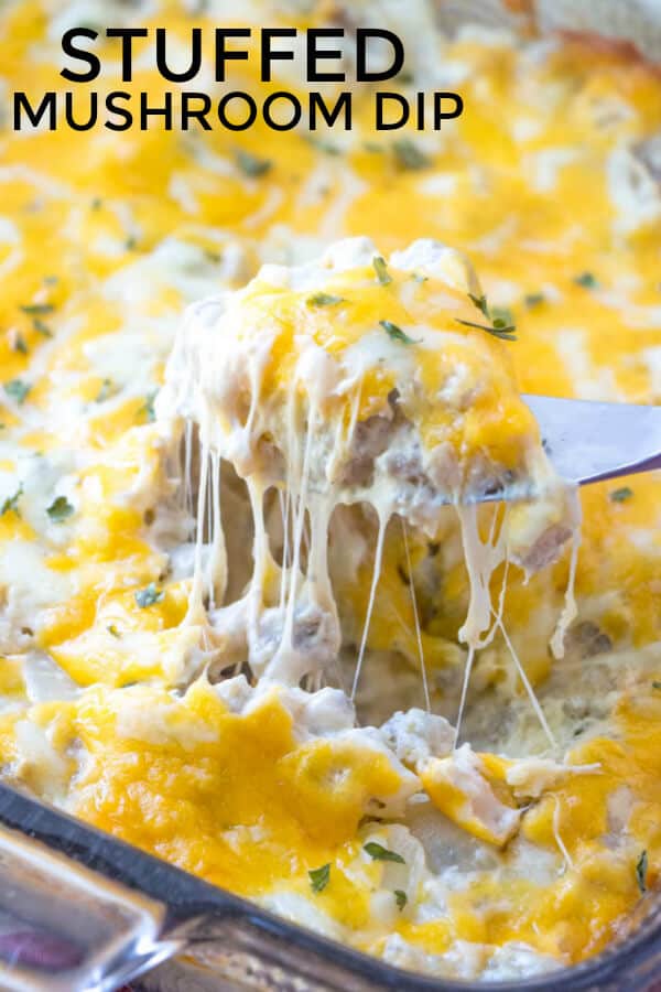 Pinterest image of stuffed mushroom dip with knife showing cheese pull