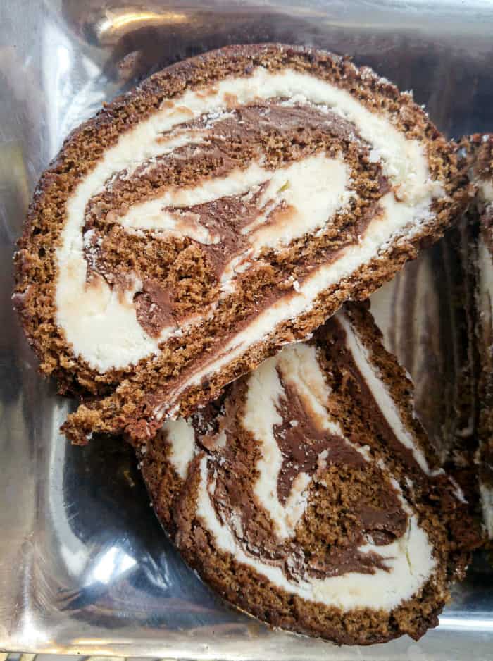 Overhead of two slices of cake roll on silver serving tray