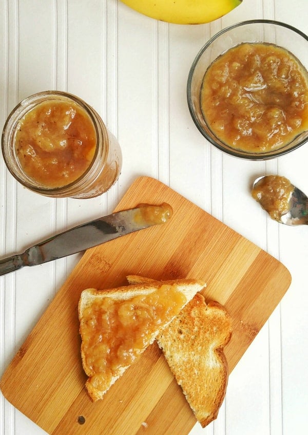 Overhead of jam in jar and spread on one slice of cut toast