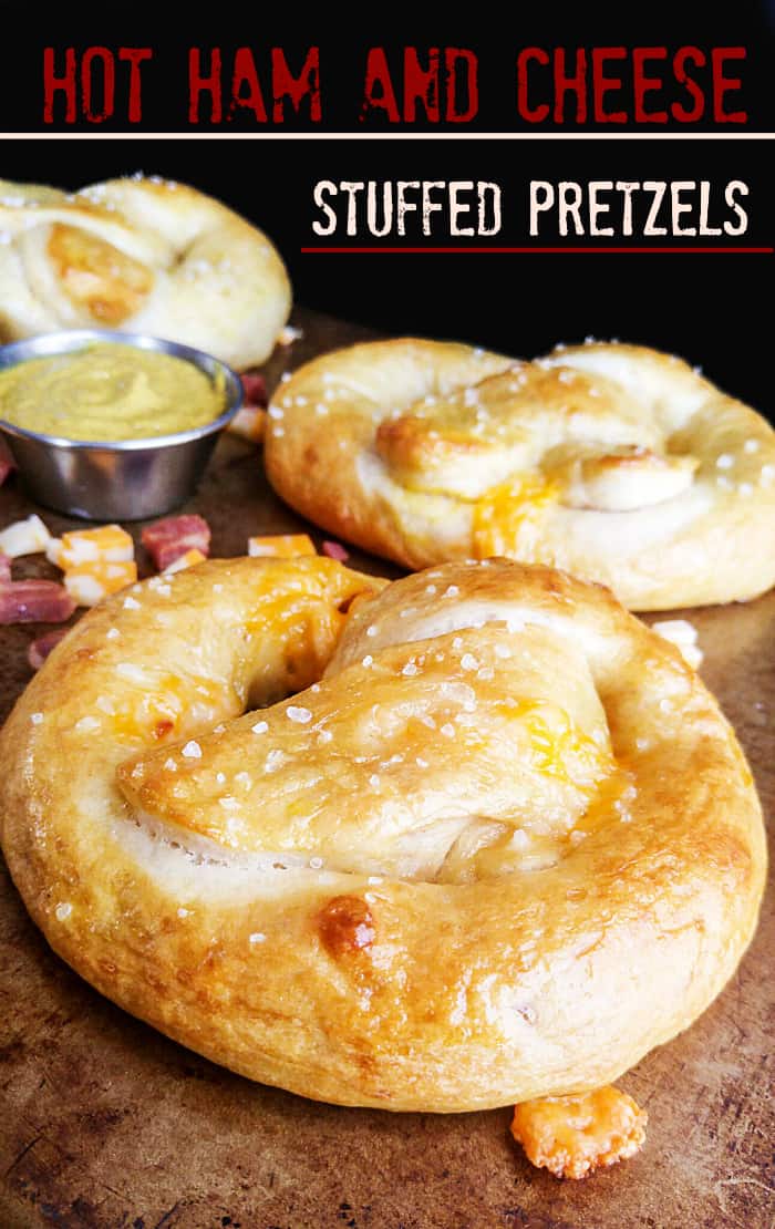 Hot Ham and Cheese Stuffed Pretzels on baking sheet with salted top