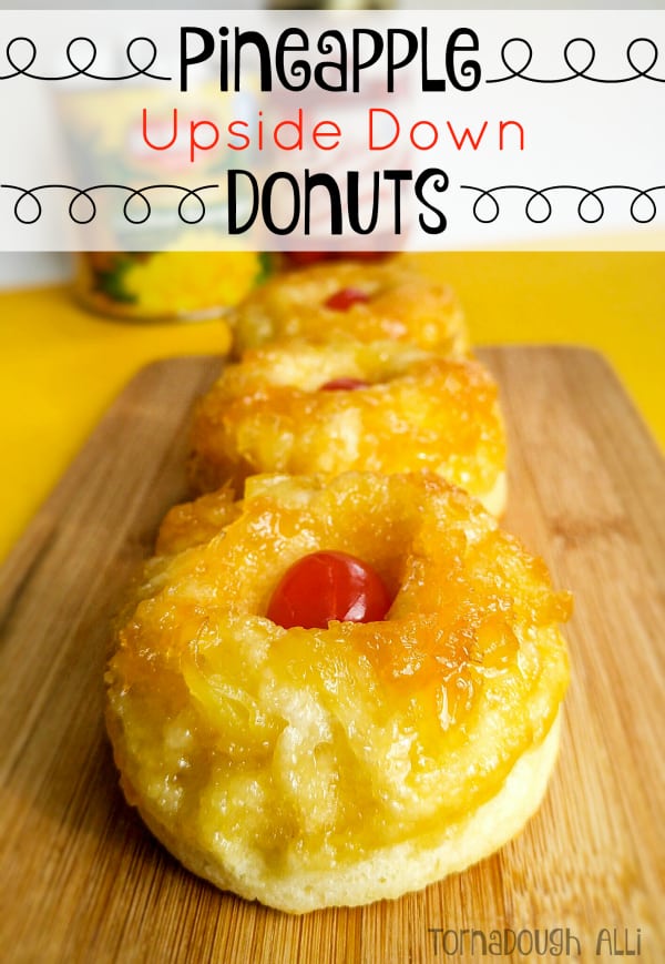 Pineapple Upside Down Donuts on brown cutting board topped with cherry