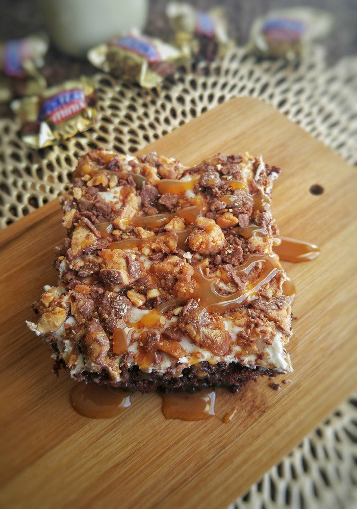 Overhead of slice of snickers cake drizzled in caramel sauce