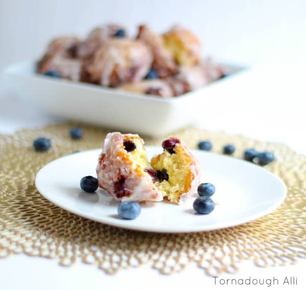 One split Fritter on white plate with blueberries