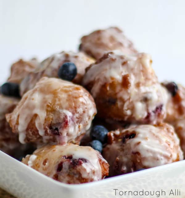 Blueberry Lemon Fritters glazed and stacked in white dish