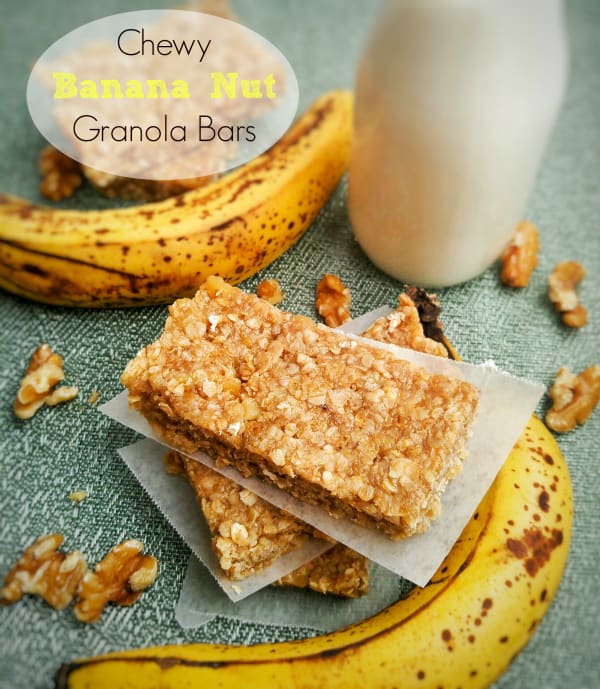 Chewy Banana Nut Granola Bars stacked on top of one another separated by parchment paper