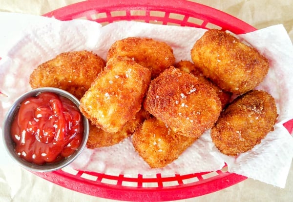 Overhead of tater tots in basket with side of ketchup