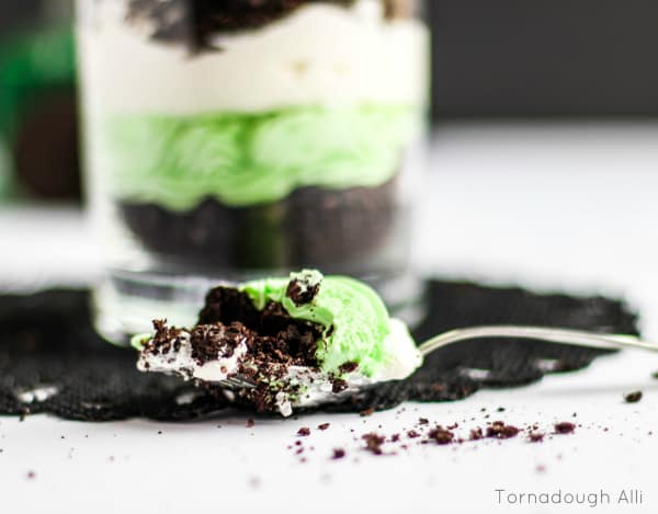 Spoon holding scooped Mint Cheesecake and Oreo Trifle mix