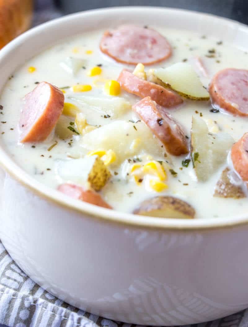 Up close of Sausage and Corn Chowder in white bowl