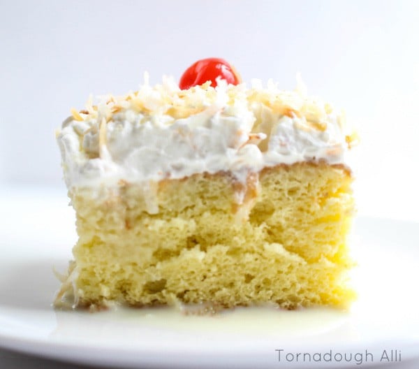 Tres Leche Cake side showing whipped topping coconut and cherry