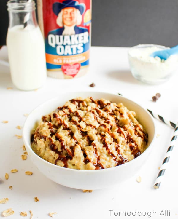 Boston Cream Pie Oatmeal in white bowl drizzled with chocolate syrup