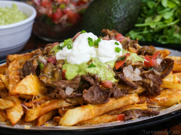 Carne Asada Fries topped with guacamole, pico de Gallo and sour cream