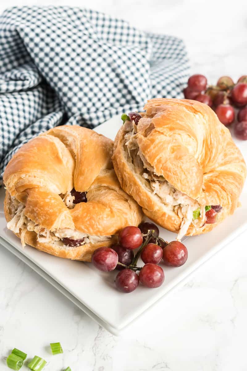 Chicken Salad recipe on croissants on plate with grapes