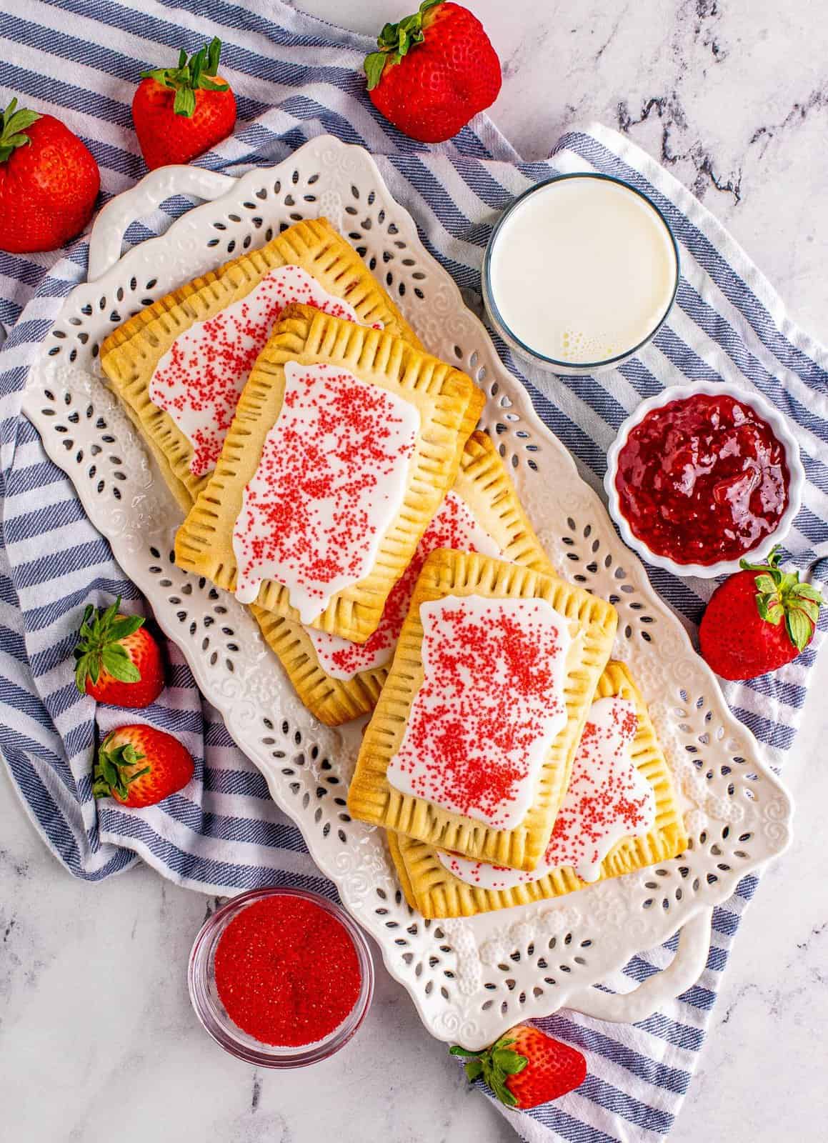 Overhead of Homemade Strawberry Pop-Tarts glazed and sprinkled with sanding sugar.