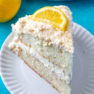 Lemon Crumb Cake on white plate topped with lemon slice