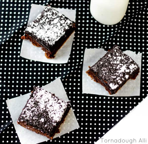 Overhead of three Oreo Truffle Brownies on parchment paper