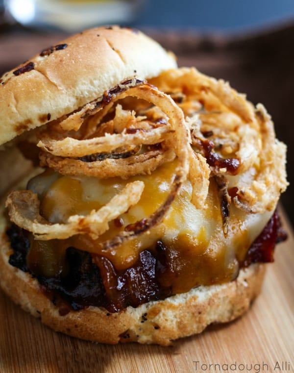 Meatloaf sandwich topped with melted cheese and onion straws