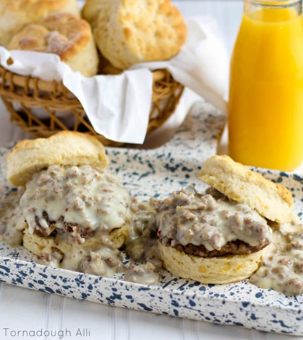 Two Cheddar Biscuits topped with sausage patty and sausage gravy
