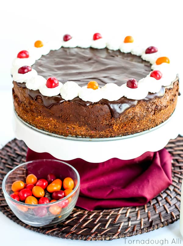 Chocolate Chili Cheesecake on cake stand with M&M's in Bowl
