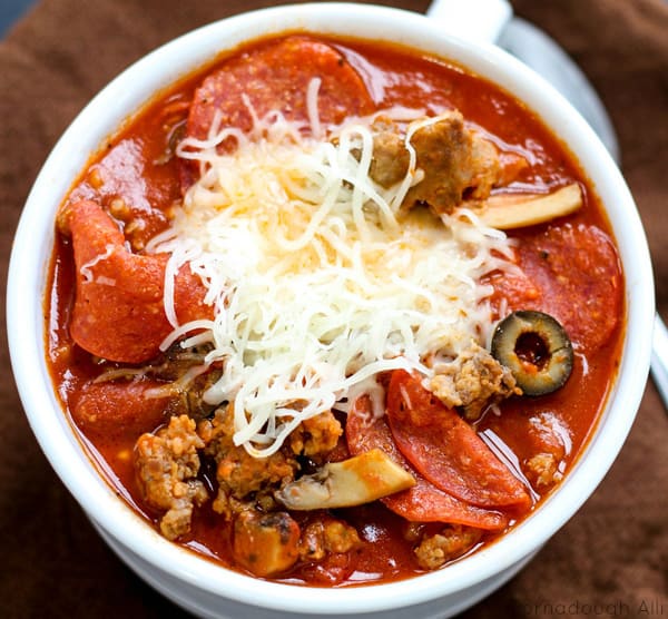 Overhead of Chili in bowl with cheese showing meats and vegetables