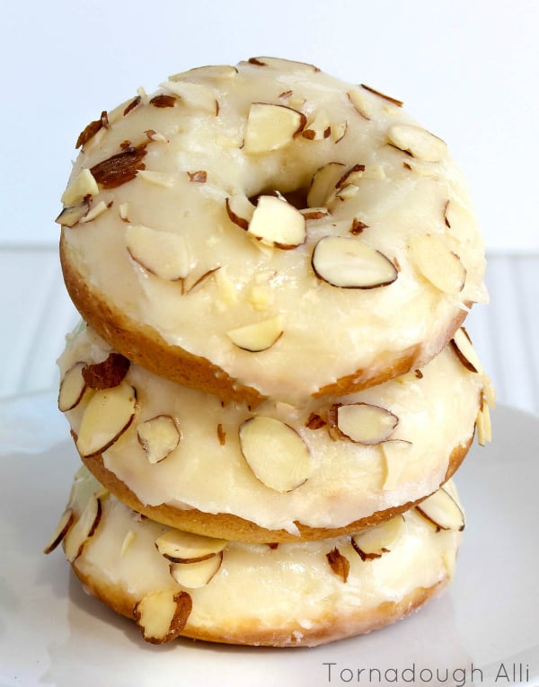 Three stacked Texas Almond Sheet Cake Donuts on white plate
