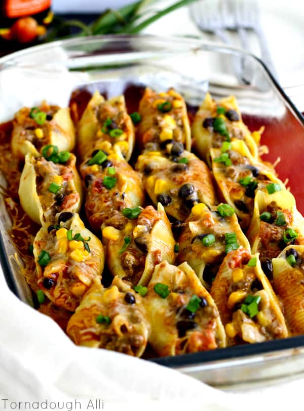 Delicious Mexican Stuffed Shells stuffed with creamy cheesy veggies and beef in baking dish