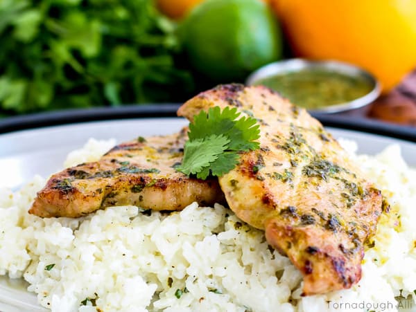 Mojo Pork Chops with Cilantro Sour Cream Rice garnished with cilantro