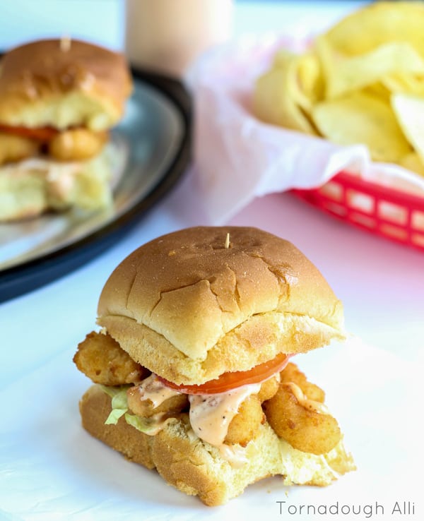 Overhead of finished sliders on buns showing dripping sauce