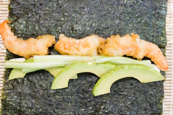 Tempura shrimp, avocado and sliced cucumber on seaweed