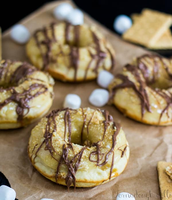 S'mores Donuts on brown parchment with marshmallows