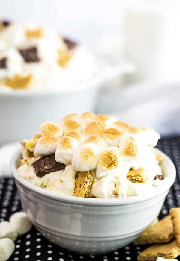 Bowl of S'mores No Bake Cheesecake Fluff topped with toasted marshmallows
