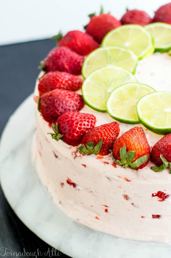 Strawberry Lime Cake on marble stand topped with strawberry and lime slices