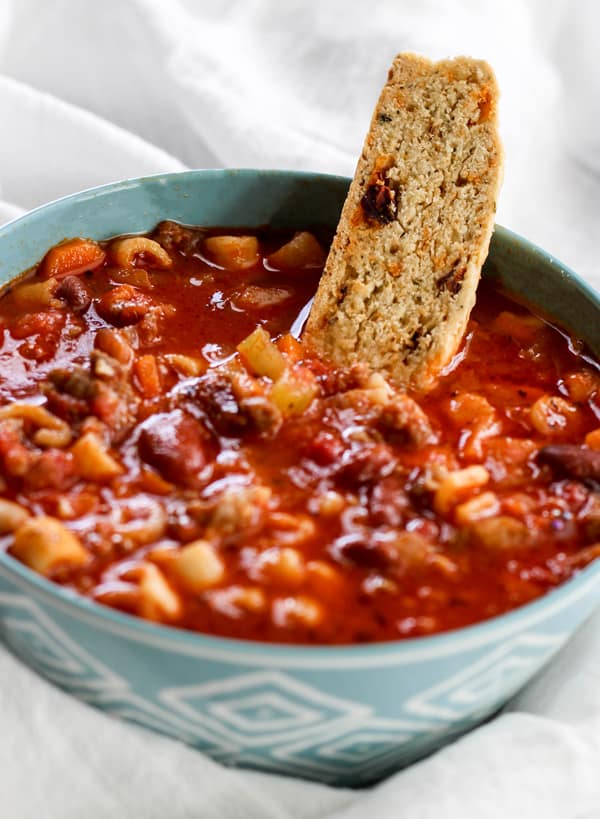 Delicious Sun-Dried Tomato and Herb Biscotti in a bowl of soup