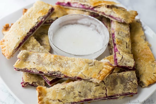 Blackberry Cream Cheese Pie Dippers on plate with dipping sauce in middle