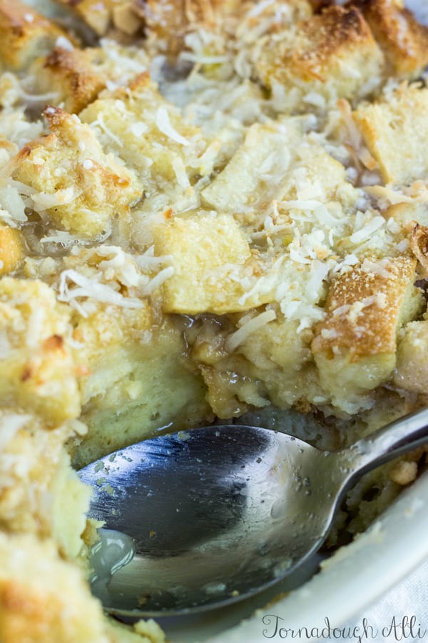 Close up of Bread Pudding with serving spoon and some pudding missing