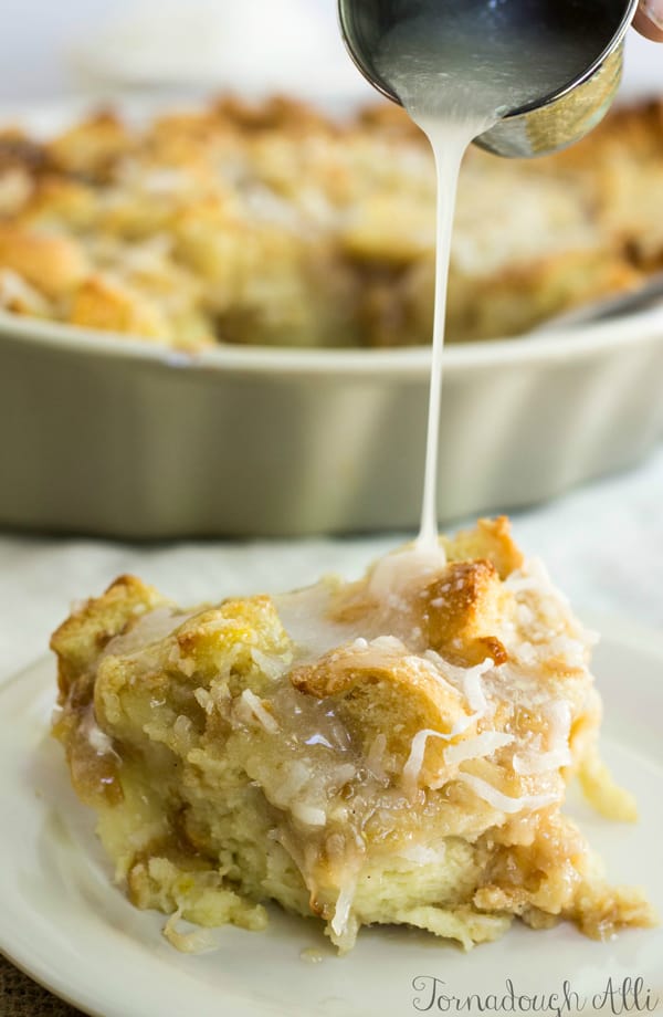 Sauce being poured onto Bread Pudding