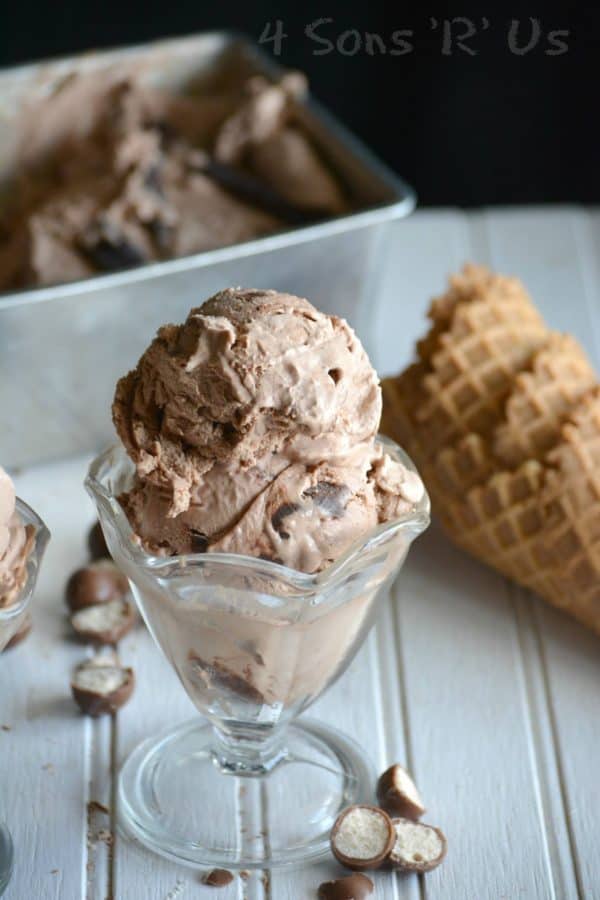 Chocolate Malt Crunch Ice Cream in serving dish with waffle cones beside it