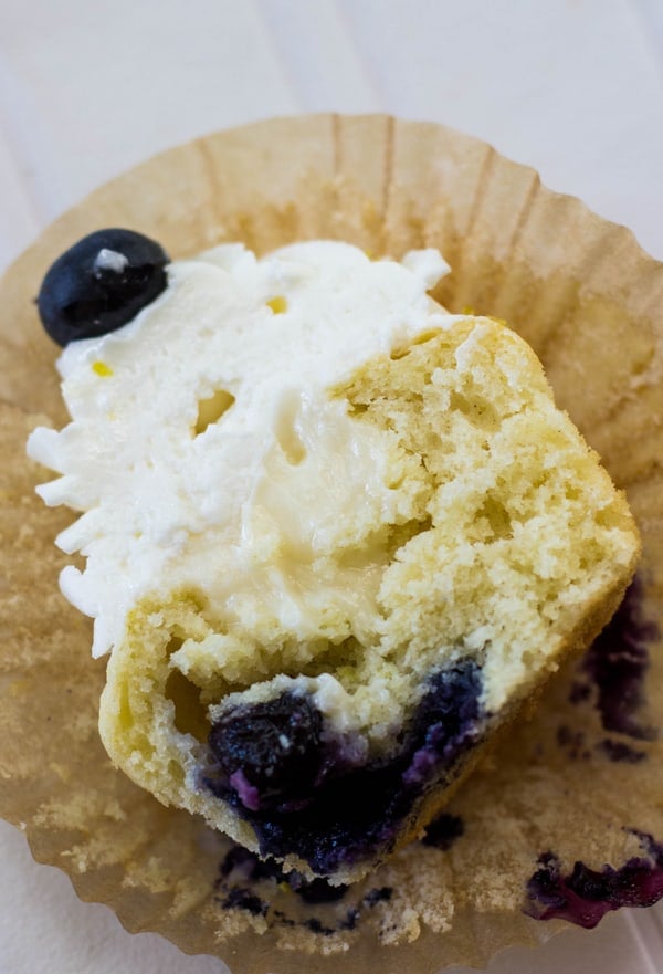 Cheesecake Stuffed Lemon Blueberry Cupcake sliced in half showing center
