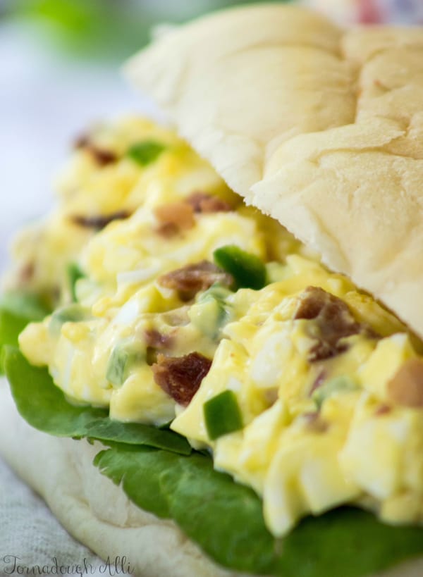 Close up of egg salad with lettuce on bun