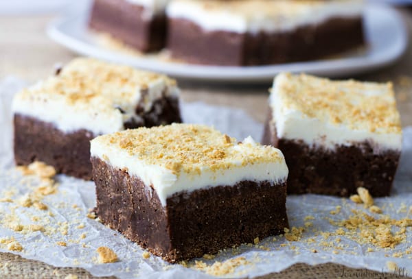 Three S'mores Fudge Brownies on parchment paper