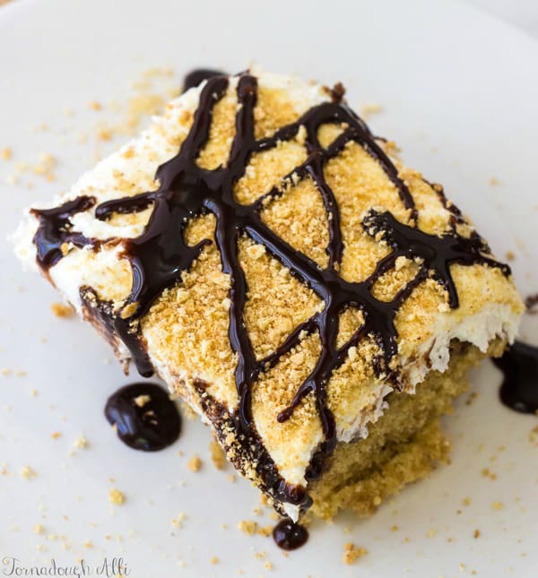 Overhead of S'mores Poke Cake drizzled in chocolate