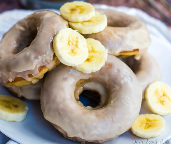 Close of up stacked donuts on plate with banana slices