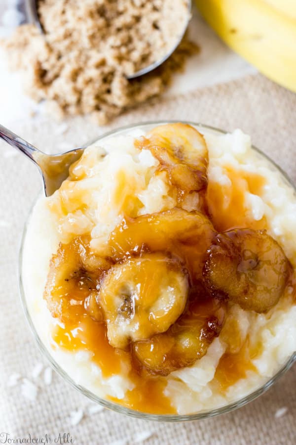 Spoon taking bite out of Bananas Foster Rice Pudding